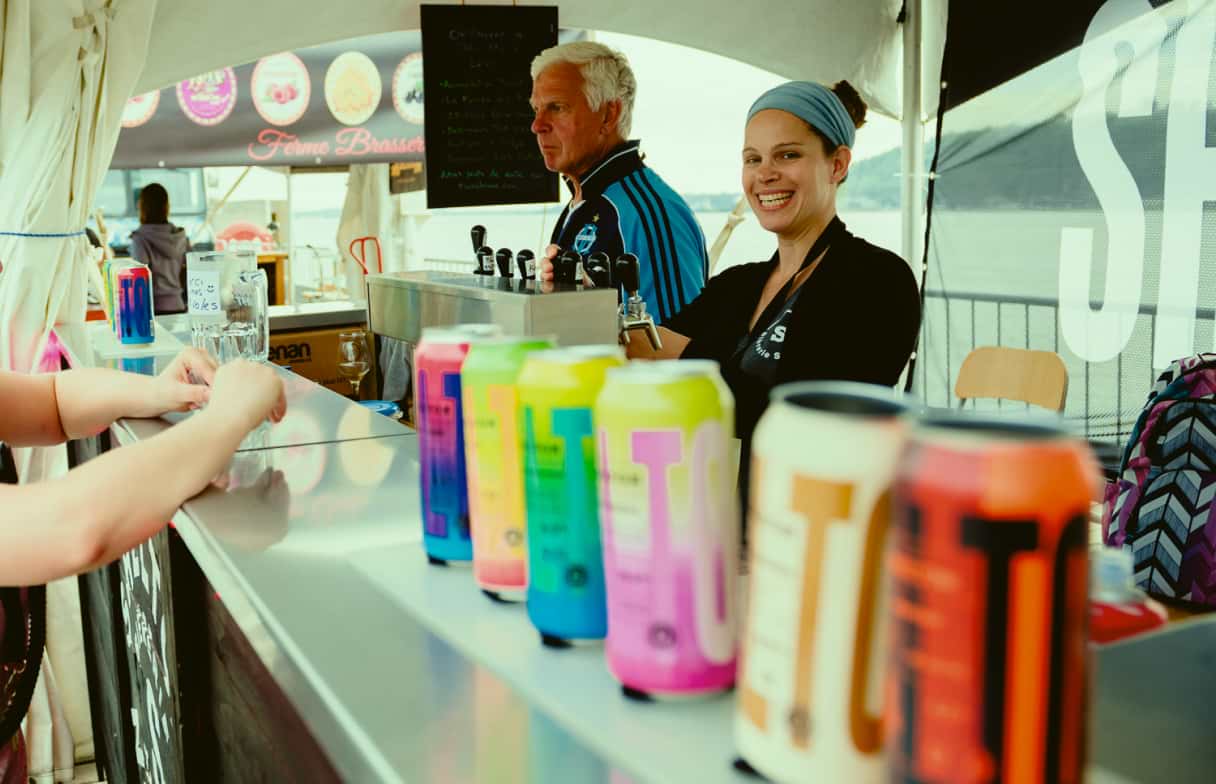 Maude and Darryl's father in their kiosk of a microbrewery festival event